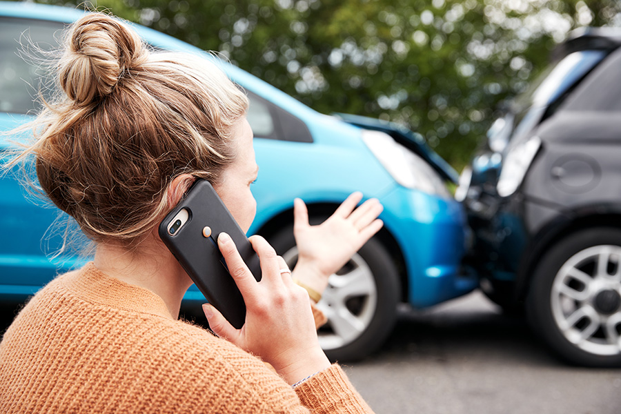 woman on phone after motor vehicle accident