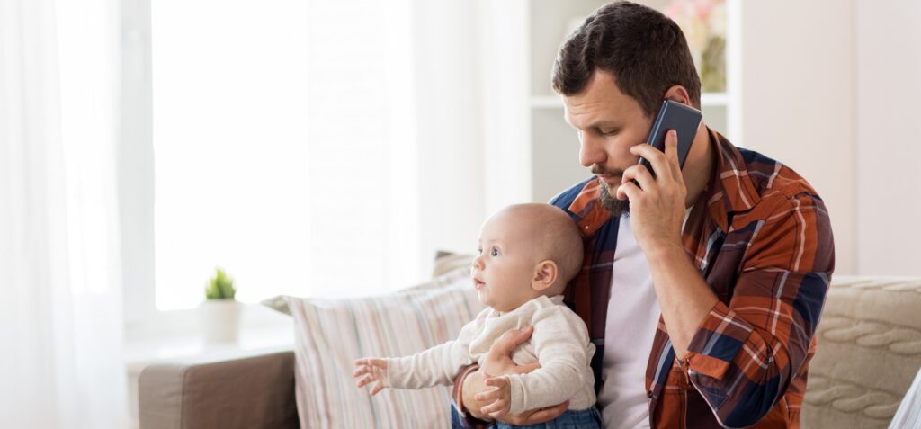 father with baby calling financial counsellor